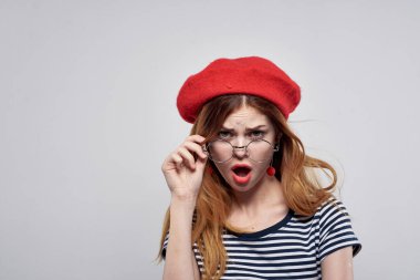 Kırmızı şapka takan güzel bir kadın. Makyaj modası. Temiz hava alıyor.