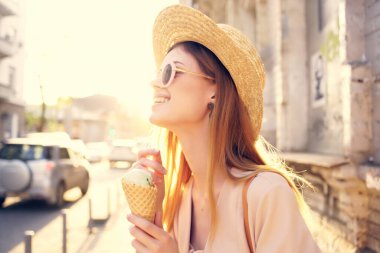 Güzel bir kadın dışarıda yürüyor. Dondurma yiyor. Seyahat modeli.