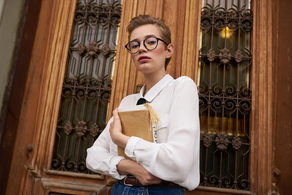 Student with glasses walking around the city with a book communication — Stock Photo, Image