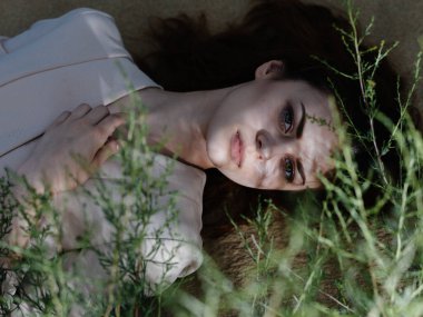 Ceketli çekici kadın kum gezisi modasında yatıyor.