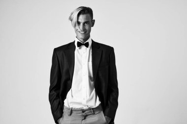 Takım elbiseli adam papyon takıyor, saç stili zarif model.