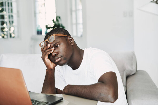 man african appearance at home in front of laptop working online
