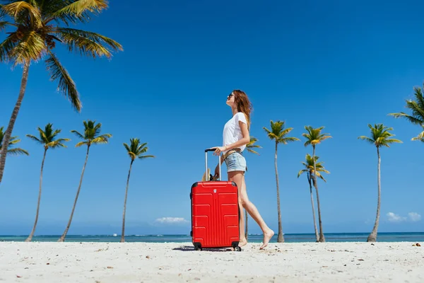 Woman with red suitcase on palm island travel fresh air — Stock Photo, Image