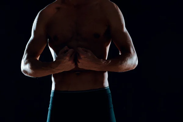 Mann mit muskulösem Bauch abgeschnitten Blick auf Turnhalle dunklen Hintergrund — Stockfoto