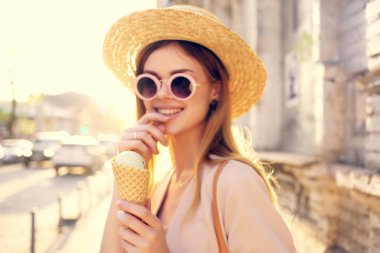 Güzel bir kadın dışarıda yürüyor. Dondurma yiyor. Seyahat modeli.