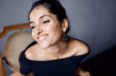 Esmer modelin çekici görünüşü dekorasyon gülüşü koyu arkaplan