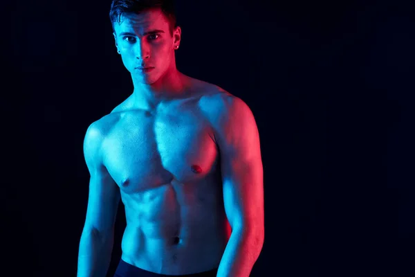 Portrait of an attractive guy with a pumped-up torso bodybuilder black background cropped view — Stock Photo, Image
