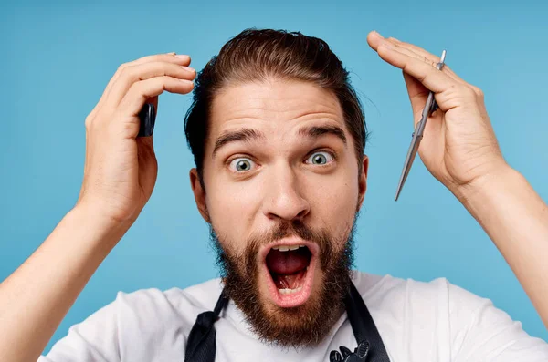 bearded man scissors comb blue background