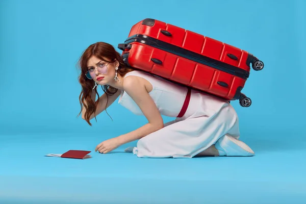 cheerful woman passenger luggage airport flight blue background