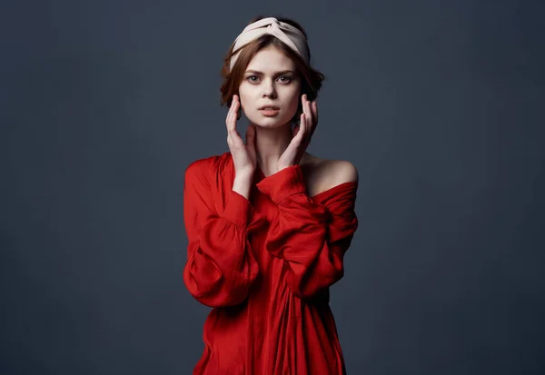 Mulher com headband decoração vestido vermelho luxo fundo escuro — Fotografia de Stock