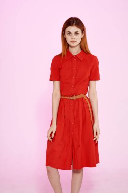 Kırmızı elbiseli güzel kadın lüks stüdyoda el kol hareketi yapıyor.