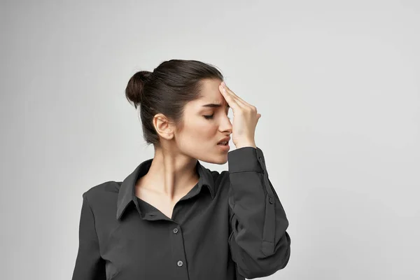 Женщина в черной рубашке держа голову депрессивный изолированный фон — стоковое фото