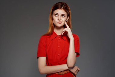 Stüdyoda poz veren kırmızı elbiseli kızıl saçlı kadın. Yüksek kalite fotoğraf