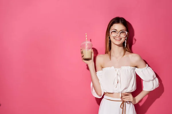 pretty woman with drink  pink background. High quality photo