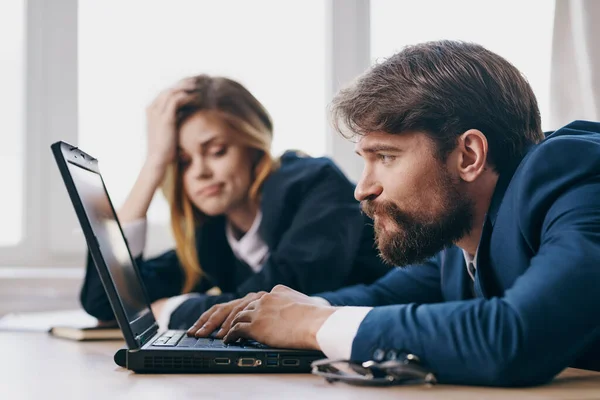 Hombre y mujer de negocios en la oficina delante de un ordenador portátil funcionarios de trabajo de carrera — Foto de Stock