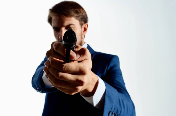 Man gun in the hands of the mafia emotions Agent light background — Stock Photo, Image