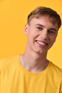 Sarı tişörtlü neşeli erkek model pozitif enerji, gençlik tarzı ve kampanyalar ve pazarlama görselleri için uygun yaşam tarzı markalaştırıyor.