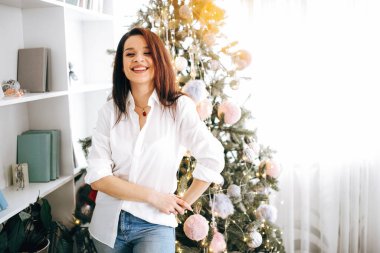 - Mutlu yıllar. Güzel esmer bekliyor ve Noel ağacının yanında hediyeler alıyor.