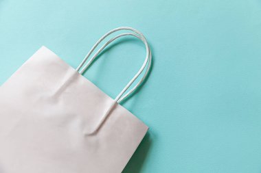 Kısaca mavi pastel arka planda izole edilmiş tasarım alışveriş çantası. İnternetten ya da alışveriş merkezinden alışveriş konsepti. Kara Cuma Noel sezonu indirimi. Düz görünüm fotokopi alanı maketi