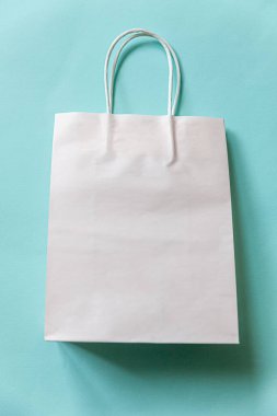 Kısaca mavi pastel arka planda izole edilmiş tasarım alışveriş çantası. İnternetten ya da alışveriş merkezinden alışveriş konsepti. Kara Cuma Noel sezonu indirimi. Düz görünüm fotokopi alanı maketi