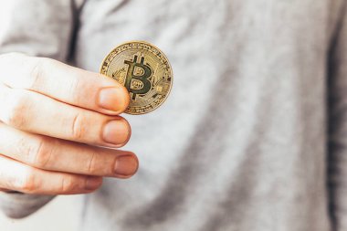 Şifreli altın bitcoin parayı tutan adam. İnternet bankacılığı ve uluslararası ağ ödemeleri için elektronik sanal para. Şifreli sanal para biriminin sembolü. Madencilik kavramı