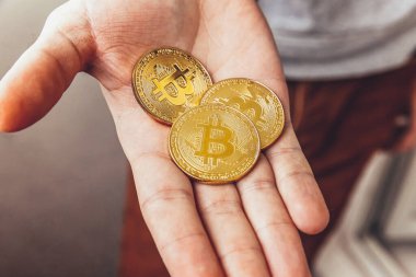 Şifreli altın bitcoin parayı tutan adam. İnternet bankacılığı ve uluslararası ağ ödemeleri için elektronik sanal para. Şifreli sanal para biriminin sembolü. Madencilik kavramı