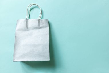 Kısaca mavi pastel arka planda izole edilmiş tasarım alışveriş çantası. İnternetten ya da alışveriş merkezinden alışveriş konsepti. Kara Cuma Noel sezonu indirimi. Düz görünüm fotokopi alanı maketi