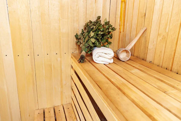 Interior details Finnish sauna steam room with traditional sauna accessories basin birch broom scoop felt hat towel. Traditional old Russian bathhouse SPA Concept. Relax country village bath concept