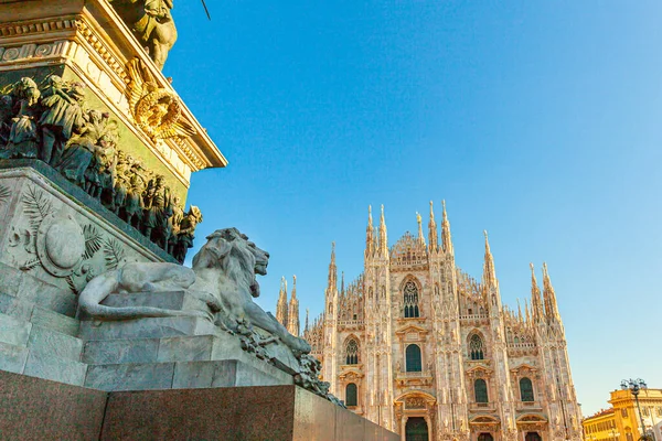 Lion marble statue near famous church Milan Cathedral Duomo di Milano. Panoramic view of top tourist attraction on piazza in Milan Lombardia Italy. Wide angle view of old Gothic architecture and art