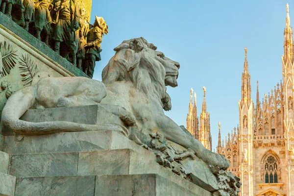 Lion marble statue near famous church Milan Cathedral Duomo di Milano. Panoramic view of top tourist attraction on piazza in Milan Lombardia Italy. Wide angle view of old Gothic architecture and art