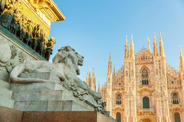 Lion marble statue near famous church Milan Cathedral Duomo di Milano. Panoramic view of top tourist attraction on piazza in Milan Lombardia Italy. Wide angle view of old Gothic architecture and art