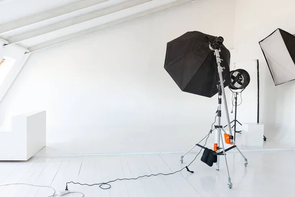 stock image Empty photo studio with lighting equipment. Photographer workplace interior with professional tool set gear. Flash light, white background scenes ready for studio shooting. Modern photographer studio