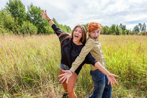 Summer holidays vacation happy people concept. Loving couple having fun together in nature outdoors. Happy young man dancing hugging with his girlfriend. Happy loving couple outdoor at summertime