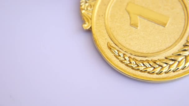 Top view of winner or champion gold trophy medal rotating on white background. Victory first place of competition. Winning or success concept. — Stock Video