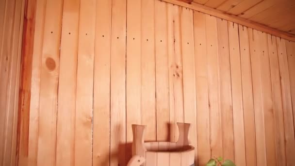 Tradiční stará ruská lázeňská koncepce lázní. Detail interiéru Finská sauna parní lázeň s tradičním saunovým příslušenstvím povodí březové koště naběračky. Relax country vesnice lázně koncept. — Stock video
