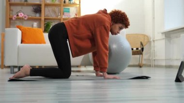 Fitness Workout training. Young healthy fit african girl doing sports exercise on yoga mat on floor at home. Athletic woman in sportswear have training workout for weight loss. Sport and fitness