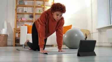 Fitness Workout training. Young healthy fit african girl doing sports exercise on yoga mat on floor at home. Athletic woman in sportswear have training workout for weight loss. Sport and fitness
