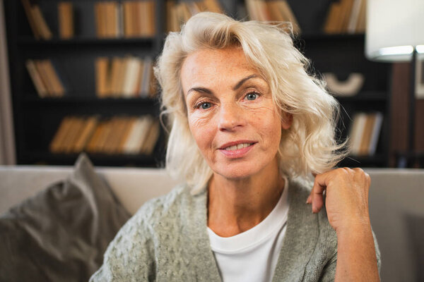 Portrait of confident stylish European middle aged senior woman. Older mature 60s lady smiling at home. Happy attractive senior female looking camera close up face headshot portrait. Happy people