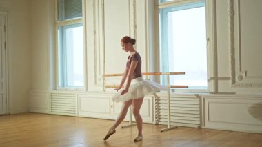 Bale dersinde etekli balerin dans ederek bale yapıyor. Dans stüdyosundaki genç klasik dansçı kadın. Bale sınıfı eğitimi. Bale okulunda dans provası yapan sanatçı kız.