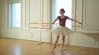 Bale dersinde etekli balerin dans ederek bale yapıyor. Dans stüdyosundaki genç klasik dansçı kadın. Bale sınıfı eğitimi. Bale okulunda dans provası yapan sanatçı kız.