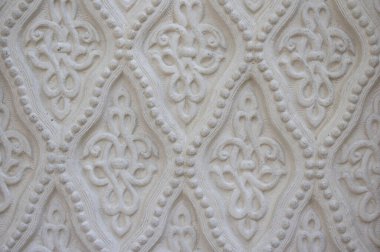 Bir deseni olan beyaz bir duvarın dokusu