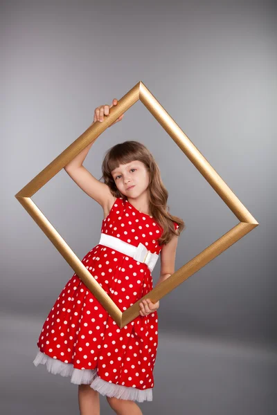 Beautiful girl holding an empty frame — Stock Photo, Image