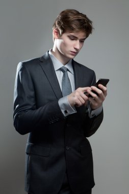 Genç işadamı cep telefonu kullanıyor.