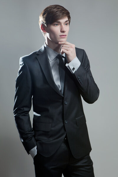 Businessman in gray suit thinking or dreaming