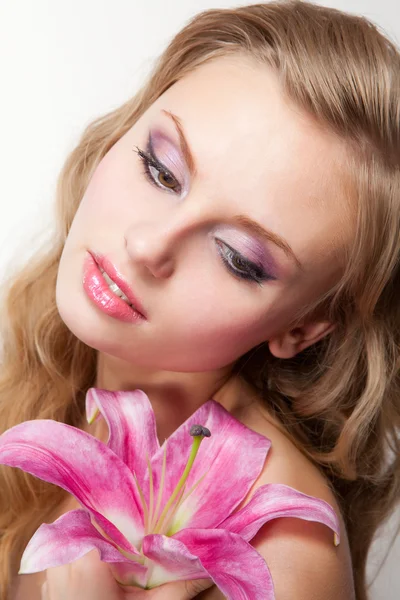 Young woman with pink lily Stock Photo