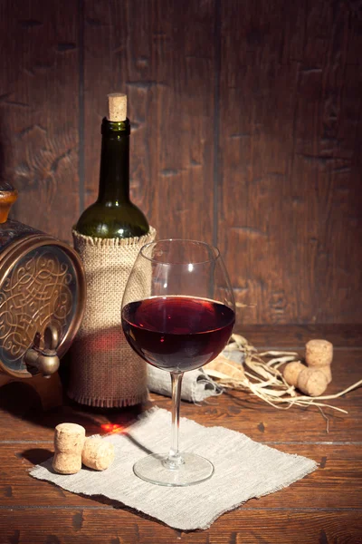 Botella de vino con vidrio sobre fondo de madera — Foto de Stock