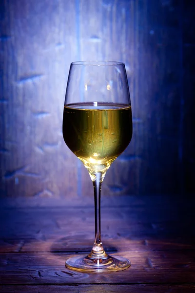 Wine glass on blue wooden background — Stock Photo, Image