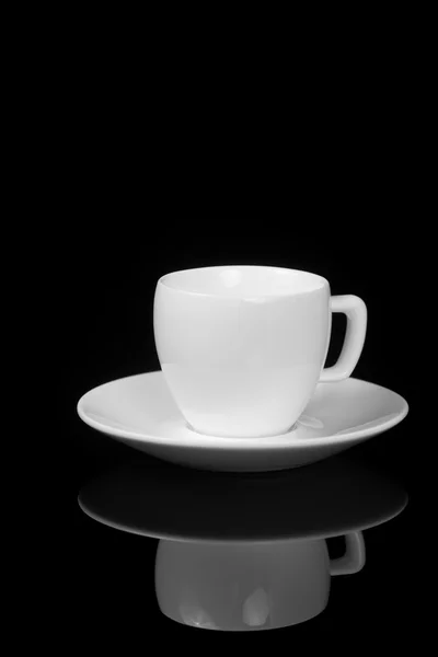 White cup on glossy black background — Stock Photo, Image