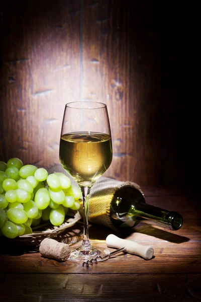 Wine bottles with glass on wooden background — Stock Photo, Image