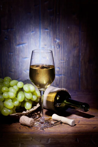 Wine bottles with glass on wooden background — Stock Photo, Image
